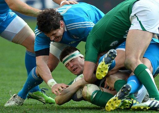 Ireland's centre Brian O'Driscoll is tackled by Italy's flanker Alessandro Zanni (L) in Rome on March 16, 2013